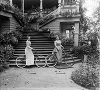 А. В. Михалкова и Н. И. Хлебникова с велосипедами у лестницы дома в усадьбе Петровское, 1880-е годы